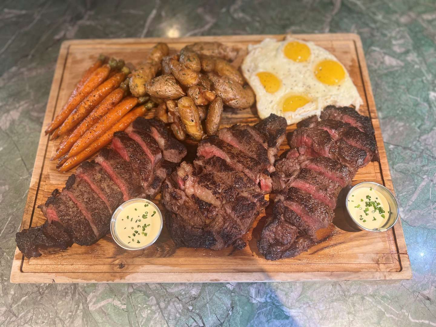 Hand selected Ribeye, four farm fresh eggs, honey glazed carrots, roasted potatoes, mustard bearnaise