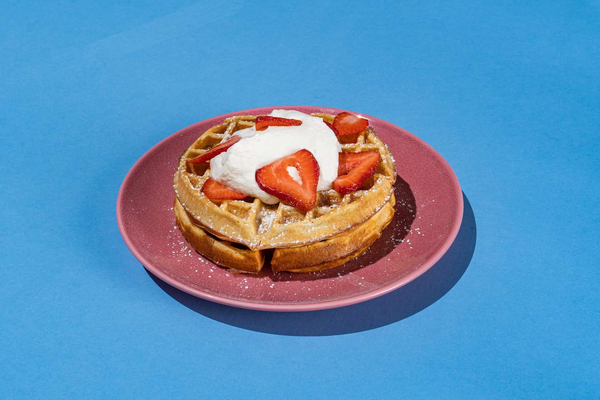 Two waffles, whipped cream, fresh strawberries